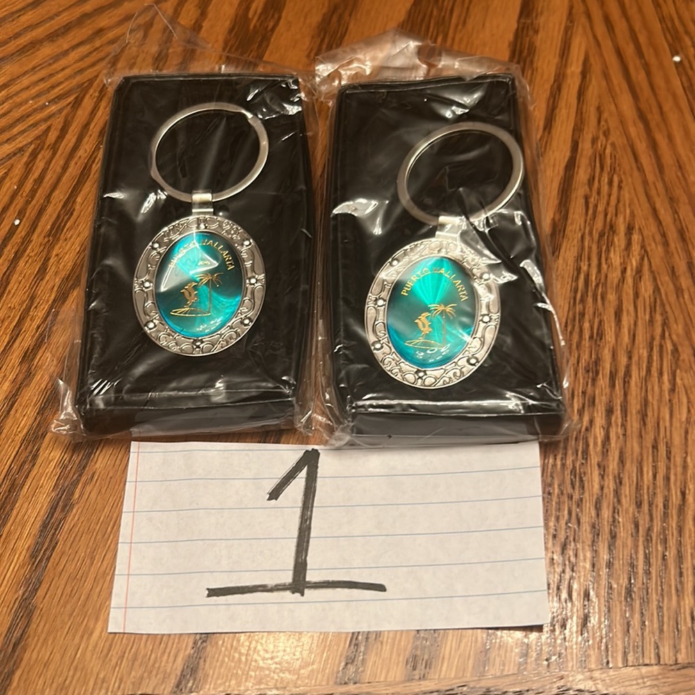 NIPB UNISEX PUERTO VALLARTA (2) EMERALD/SILVERTONE  KEYCHAIN & (1) RED KEYCHAIN.